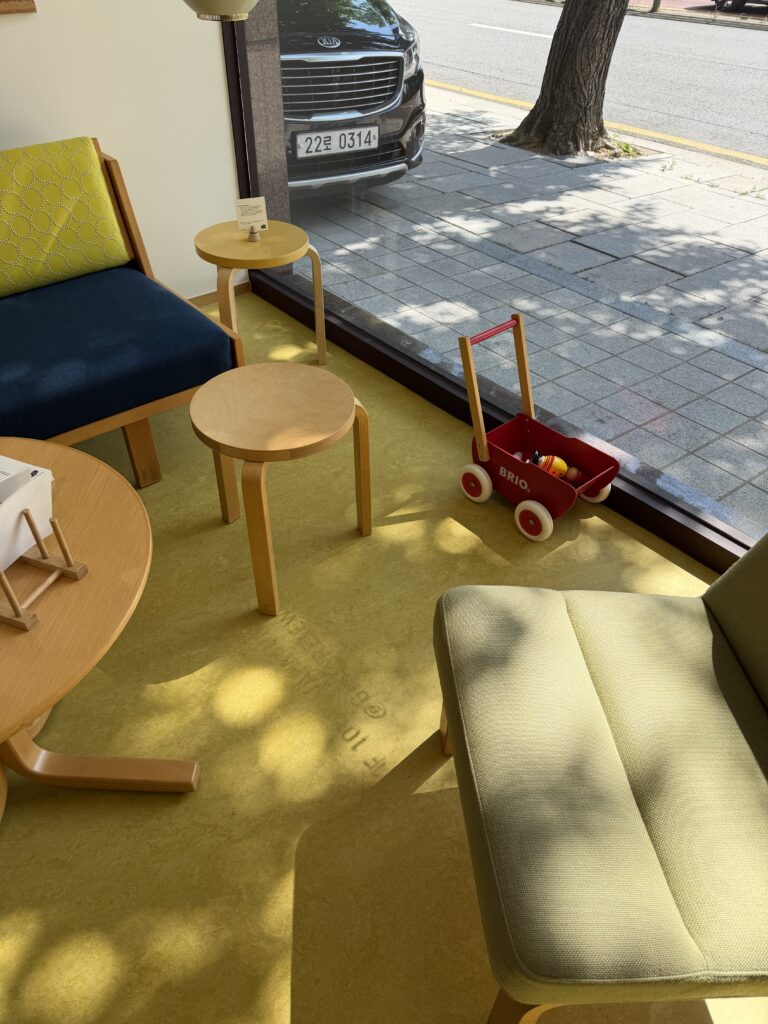 Ginger Eyewear Seochon showroom featuring yellow carpet and Artek furniture